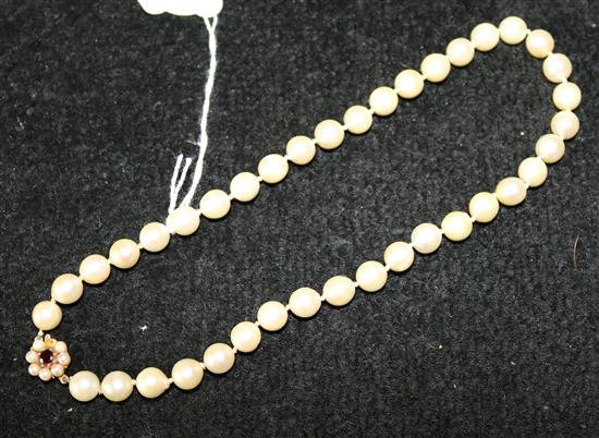 Single row of 39 uniform cultured pearls with flowerhead clasp set ruby & pearls (one deficient)